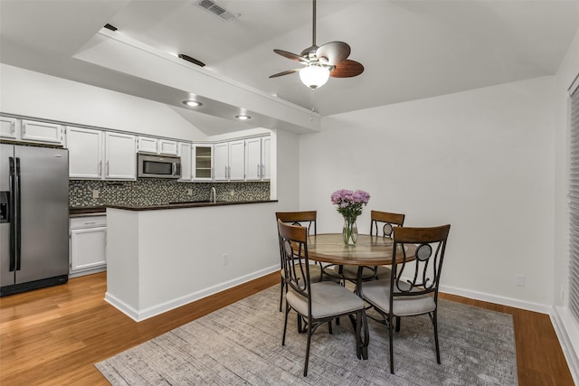 3841 Beaumont Ln, Plano, TX 75023 - dining area featuring vaulted ceiling, ceiling fan, light wood-style flooring, and baseboards