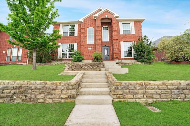view of front of home featuring brick siding and a front yard
