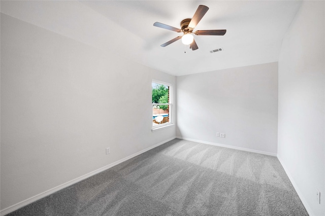 carpeted empty room featuring a ceiling fan and baseboards