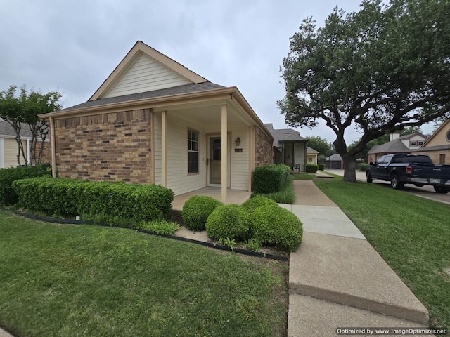 4115 Hollow Oak Dr, Dallas, TX 75287 - view of property exterior with a yard, brick siding, and a shingled roof
