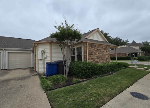 4115 Hollow Oak Dr, Dallas, TX 75287 - view of property exterior with driveway, a lawn, brick siding, and an attached garage
