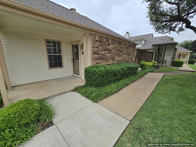 4115 Hollow Oak Dr, Dallas, TX 75287 - doorway to property featuring brick siding and roof with shingles