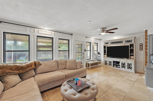 living area featuring light tile patterned flooring and a ceiling fan