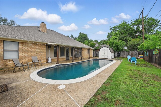 outdoor pool featuring a shed and an outdoor structure