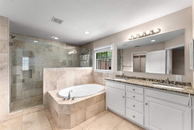 6838 Lupton Dr, Dallas, TX 75225 - bathroom with a stall shower, double vanity, a garden tub, tile patterned floors, and recessed lighting