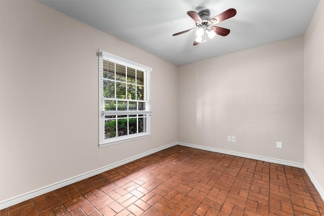 6838 Lupton Dr, Dallas, TX 75225 - unfurnished room with brick floors, a ceiling fan, and baseboards