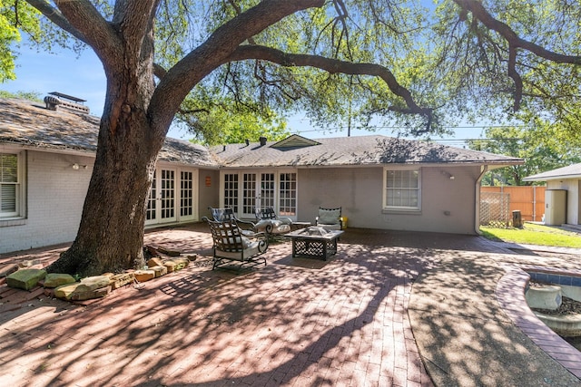 6838 Lupton Dr, Dallas, TX 75225 - rear view of property with french doors, brick siding, a patio area, and a fire pit