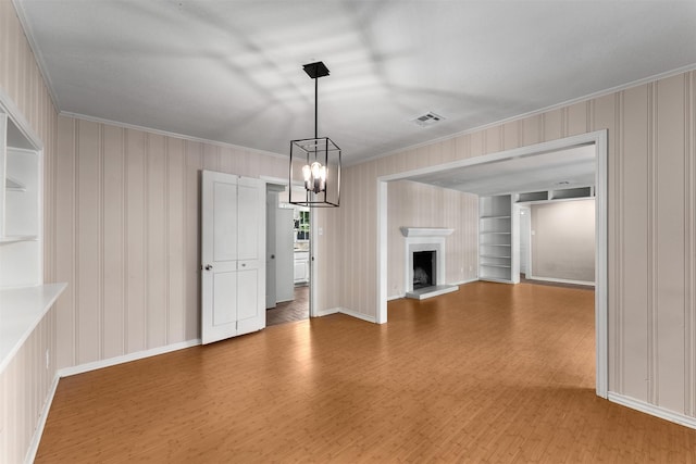 6838 Lupton Dr, Dallas, TX 75225 - unfurnished living room with crown molding, wood finished floors, a chandelier, built in features, and baseboards