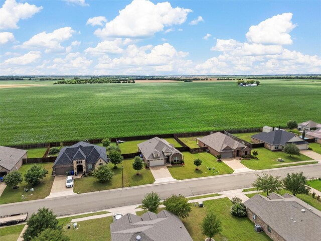 aerial view of sparsely populated area with nearby suburban area and farmland