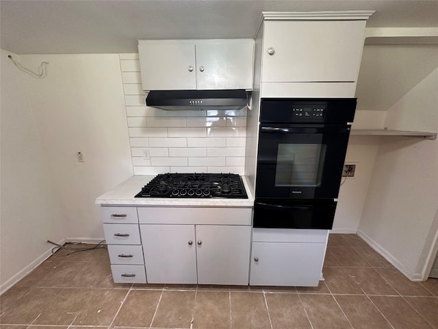 1664 Poplar Dr, Mesquite, TX 75149 - kitchen featuring black appliances, under cabinet range hood, a warming drawer, light tile patterned flooring, and decorative backsplash