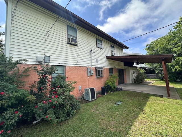 1664 Poplar Dr, Mesquite, TX 75149 - view of home's exterior featuring a yard, central AC, a patio, and brick siding