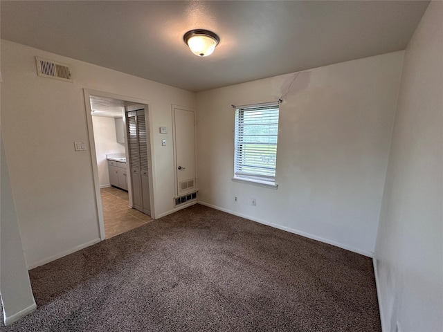 1664 Poplar Dr, Mesquite, TX 75149 - spare room featuring light carpet and baseboards