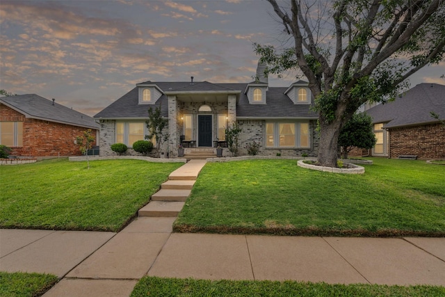 7012 Fox Dr, The Colony, TX 75056 - view of front of home with a front yard and brick siding