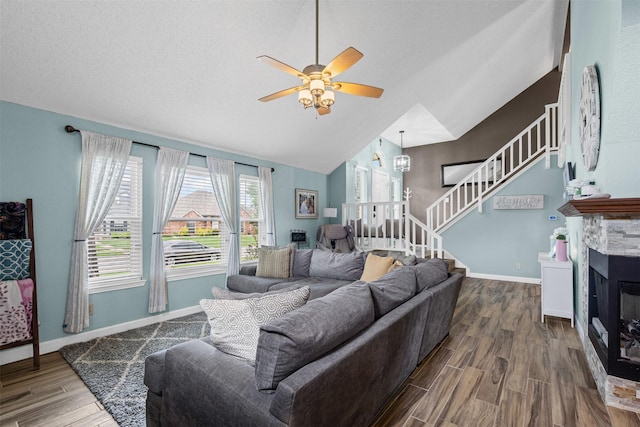 7012 Fox Dr, The Colony, TX 75056 - living area with stairs, lofted ceiling, wood finished floors, ceiling fan, and baseboards