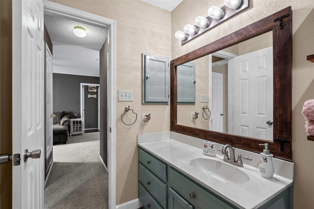 7012 Fox Dr, The Colony, TX 75056 - bathroom with vanity, a textured wall, and a textured ceiling