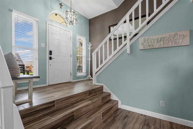 7012 Fox Dr, The Colony, TX 75056 - entrance foyer with stairs, wood finished floors, a chandelier, baseboards, and plenty of natural light