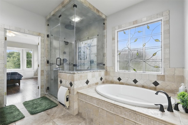 bathroom with a stall shower, a bath, and tile patterned floors
