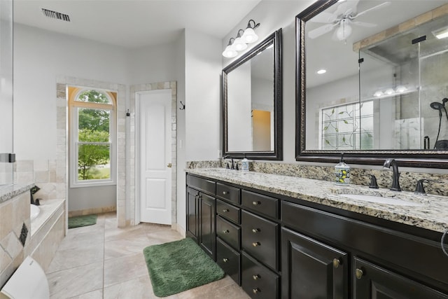 bathroom with a stall shower, double vanity, tile patterned flooring, ceiling fan, and a garden tub