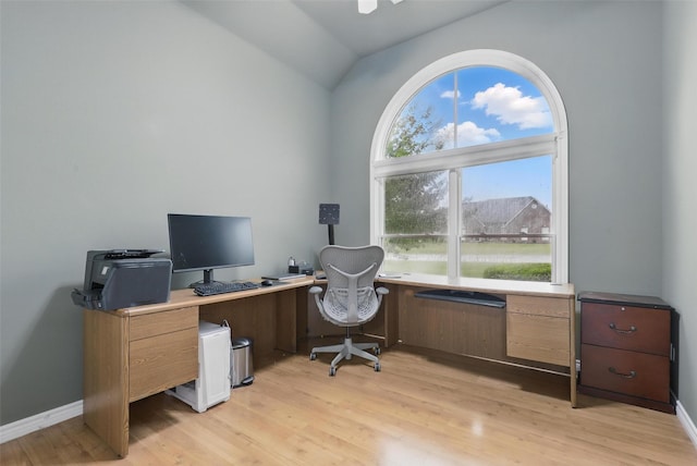 office with lofted ceiling, light wood-style floors, and baseboards