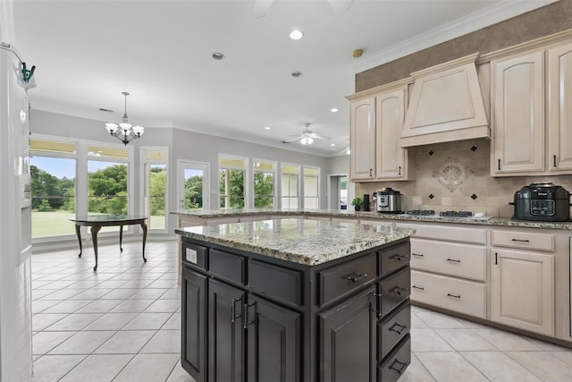 kitchen featuring ceiling fan, gas stovetop, light tile patterned floors, custom range hood, and decorative backsplash