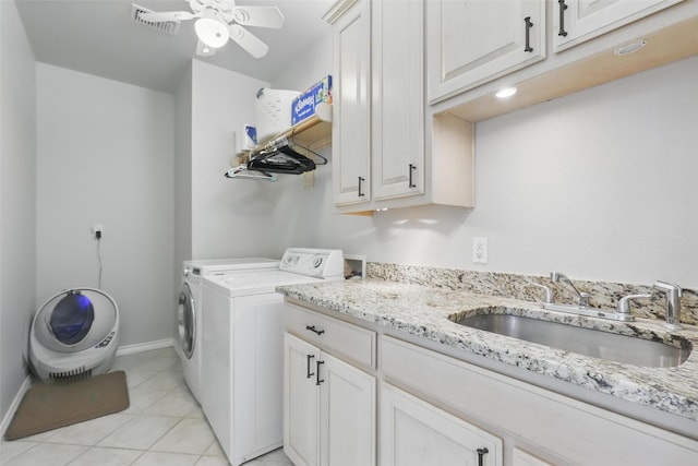 clothes washing area with cabinet space, separate washer and dryer, ceiling fan, baseboards, and light tile patterned floors