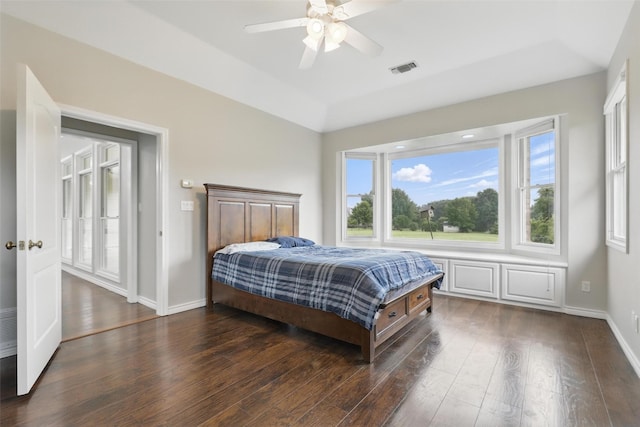 bedroom with dark wood-style floors, baseboards, and ceiling fan