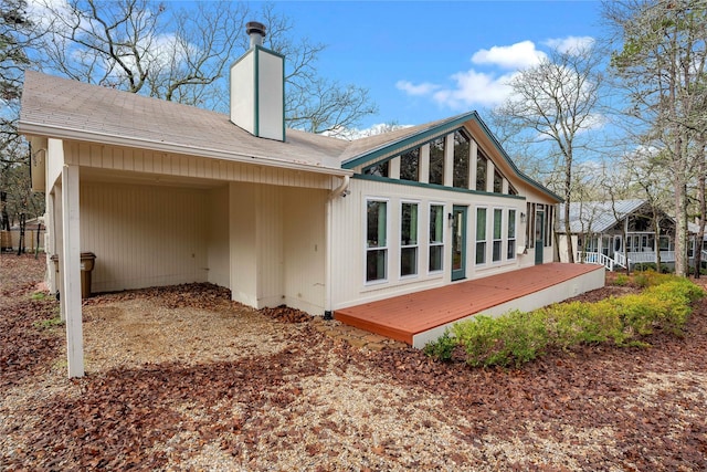 168 Knollwood Ln, Holly Lake Ranch, TX 75765 - back of property featuring a wooden deck, a chimney, and a shingled roof