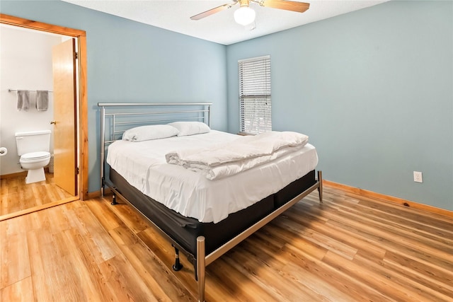 168 Knollwood Ln, Holly Lake Ranch, TX 75765 - bedroom featuring wood finished floors, baseboards, a ceiling fan, and connected bathroom