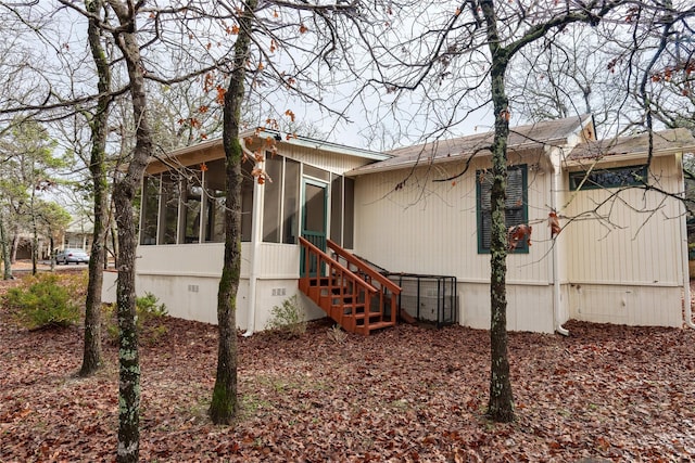 168 Knollwood Ln, Holly Lake Ranch, TX 75765 - view of home's exterior with a sunroom