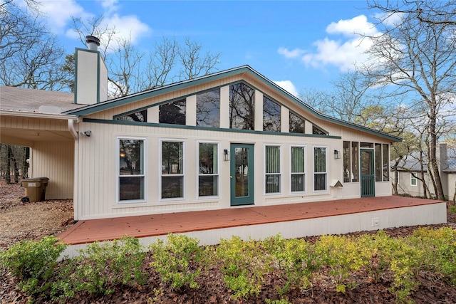168 Knollwood Ln, Holly Lake Ranch, TX 75765 - rear view of house with a sunroom, a chimney, and a deck