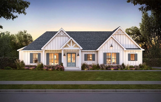 modern farmhouse with french doors, a lawn, board and batten siding, and a shingled roof