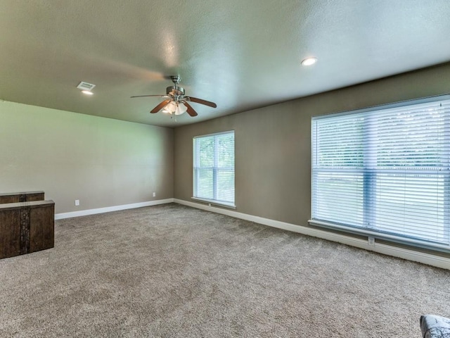 13134 Ravenview Rd, Dallas, TX 75253 - unfurnished living room featuring a ceiling fan, carpet floors, baseboards, a textured ceiling, and recessed lighting
