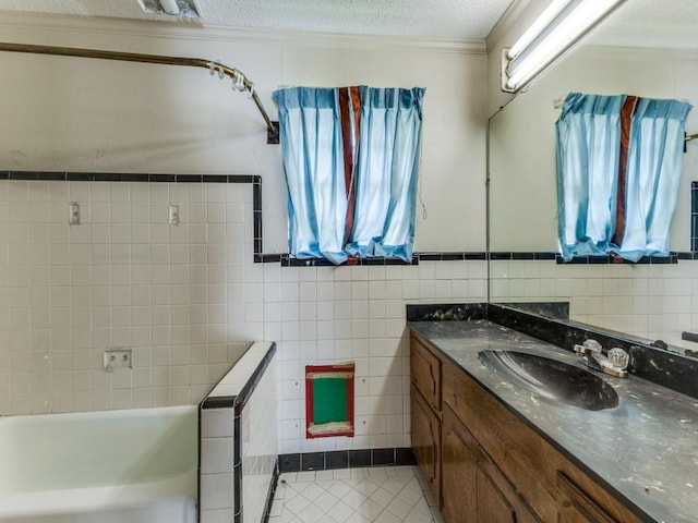 13134 Ravenview Rd, Dallas, TX 75253 - bathroom with tile patterned flooring, tile walls, vanity, healthy amount of natural light, and a textured ceiling