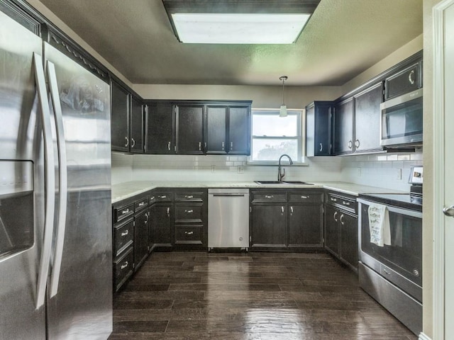 13134 Ravenview Rd, Dallas, TX 75253 - kitchen with appliances with stainless steel finishes, a sink, dark wood-type flooring, and light countertops