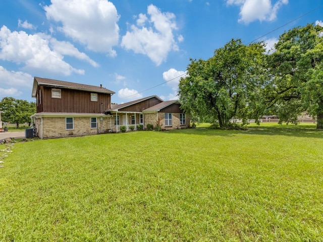 13134 Ravenview Rd, Dallas, TX 75253 - back of property with a lawn, central AC, and board and batten siding