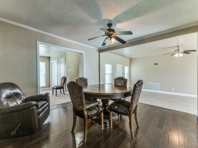 13134 Ravenview Rd, Dallas, TX 75253 - dining room featuring a ceiling fan, dark wood-style floors, crown molding, a textured ceiling, and baseboards