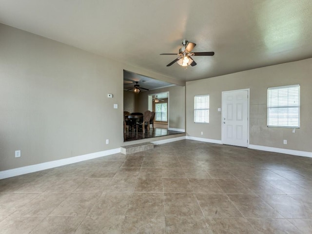 13134 Ravenview Rd, Dallas, TX 75253 - unfurnished living room featuring ceiling fan, baseboards, and tile patterned flooring
