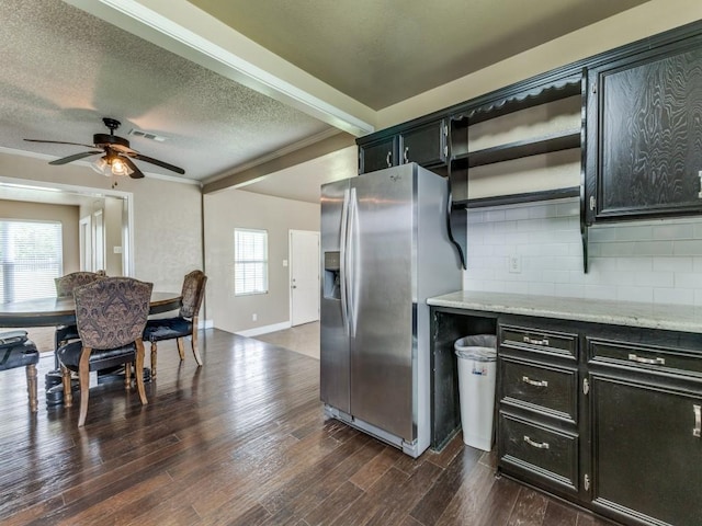 13134 Ravenview Rd, Dallas, TX 75253 - kitchen featuring stainless steel fridge with ice dispenser, dark cabinetry, decorative backsplash, a ceiling fan, and a textured ceiling