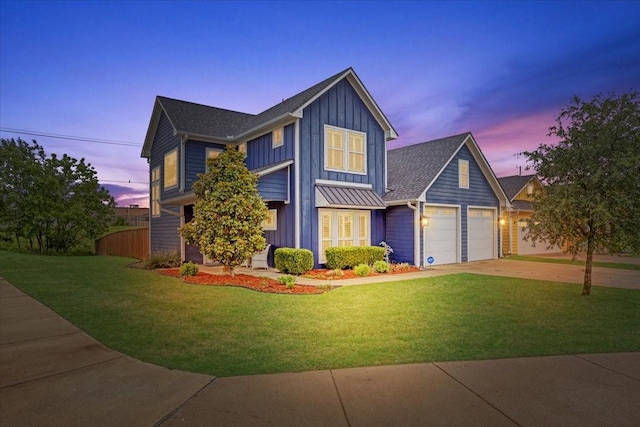 view of front of home featuring board and batten siding, an attached garage, driveway, and a standing seam roof