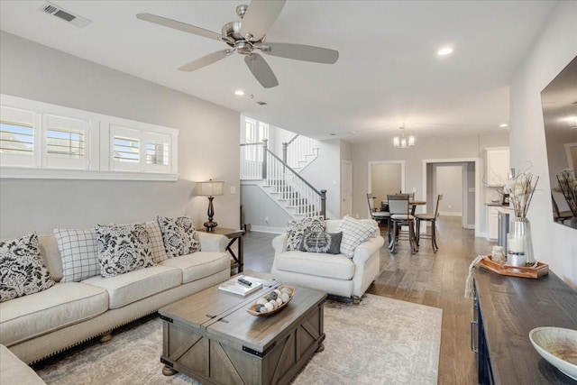 living room with stairs, light wood-type flooring, a ceiling fan, recessed lighting, and baseboards