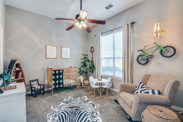 carpeted living area featuring a ceiling fan and baseboards