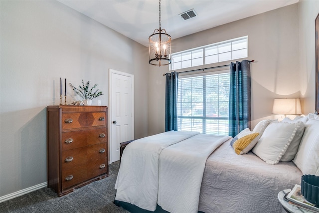 bedroom featuring dark colored carpet, a chandelier, and baseboards