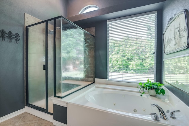 full bathroom featuring tile patterned floors, a shower stall, a jetted tub, and a textured wall