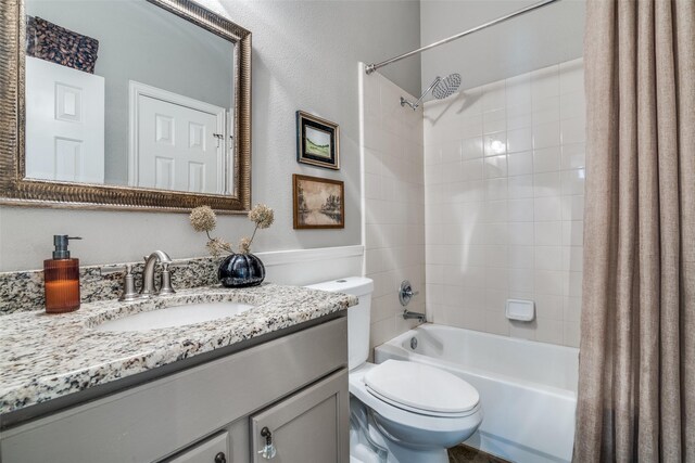 full bathroom with shower / bath combination with curtain, toilet, and vanity