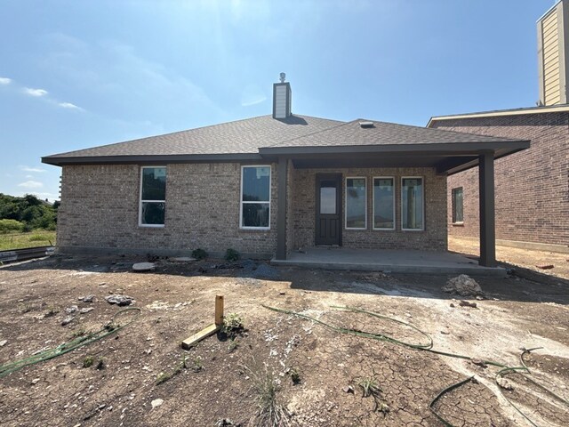 400 Tollett Dr, Aledo, TX 76008 - back of house with brick siding, a patio area, a chimney, and roof with shingles