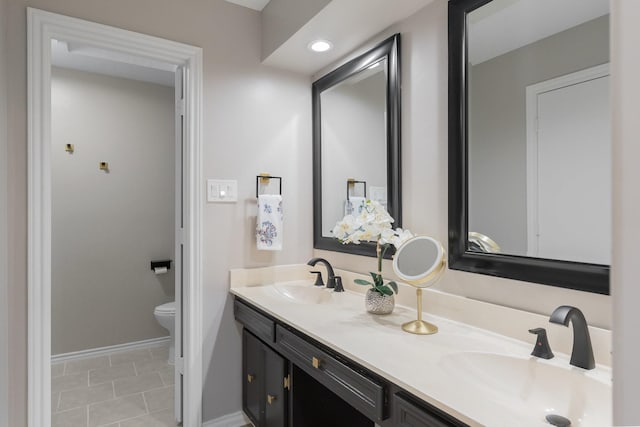 3809 Runge Ct E, Irving, TX 75038 - bathroom featuring toilet, baseboards, double vanity, and recessed lighting