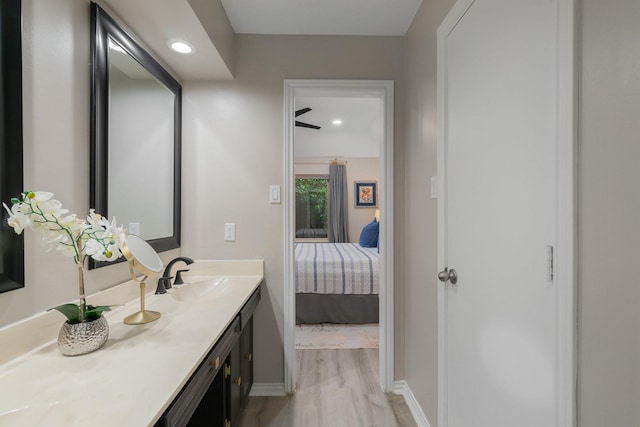 3809 Runge Ct E, Irving, TX 75038 - bathroom featuring baseboards, wood finished floors, vanity, recessed lighting, and ensuite bath