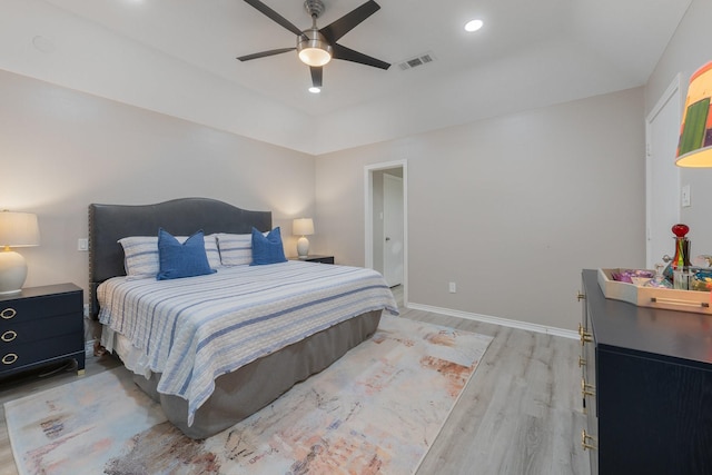 3809 Runge Ct E, Irving, TX 75038 - bedroom with light wood-type flooring, baseboards, ceiling fan, and a tray ceiling