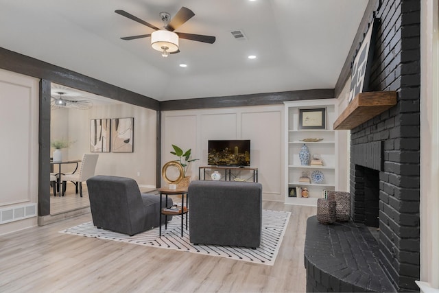 3809 Runge Ct E, Irving, TX 75038 - living area featuring light wood finished floors, ceiling fan, vaulted ceiling, a brick fireplace, and recessed lighting