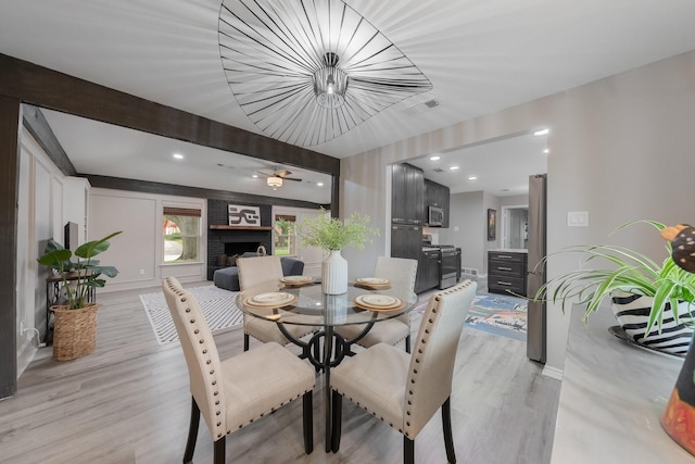 3809 Runge Ct E, Irving, TX 75038 - dining area featuring light wood finished floors, a fireplace, and baseboards